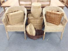 A group of wicker items including pair of armchairs, hampers,