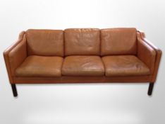 A late 20th century Danish Thams Kvalitet stitched brown leather three seater settee,