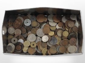 A tin containing mixed British and world coins
