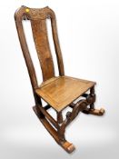 An early 20th century inlaid oak rocking chair,