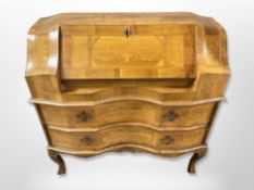 An early 20th century Continental figured walnut and satinwood inlaid serpentine fronted bureau,