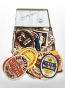 A vintage Player's Navy Cut cigarette tin together with a collection of vintage beer labels