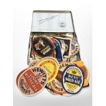 A vintage Player's Navy Cut cigarette tin together with a collection of vintage beer labels