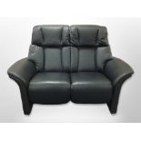 A contemporary black stitched leather two seater settee,