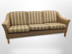 A 20th century Danish three seater settee in striped olive fabric,