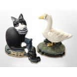 Two painted cast iron cat and duck door stops together with a further Scottie dog example,