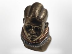 A cold-cast bronze bust of an African woman, signed 'Casper D' and dated 1981, height 11.5cm.