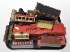 A group of vintage tin-plate rolling stock and model railway buildings, etc.