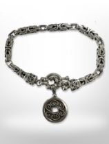 A heavy fancy silver bracelet.