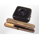 A 9ct gold-mounted cheroot, and a pocket watch travel case.