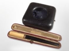 A 9ct gold-mounted cheroot, and a pocket watch travel case.
