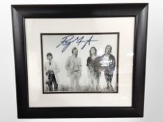 A monochrome photograph of The Doors, signed by keyboardist Ray Manzarek,