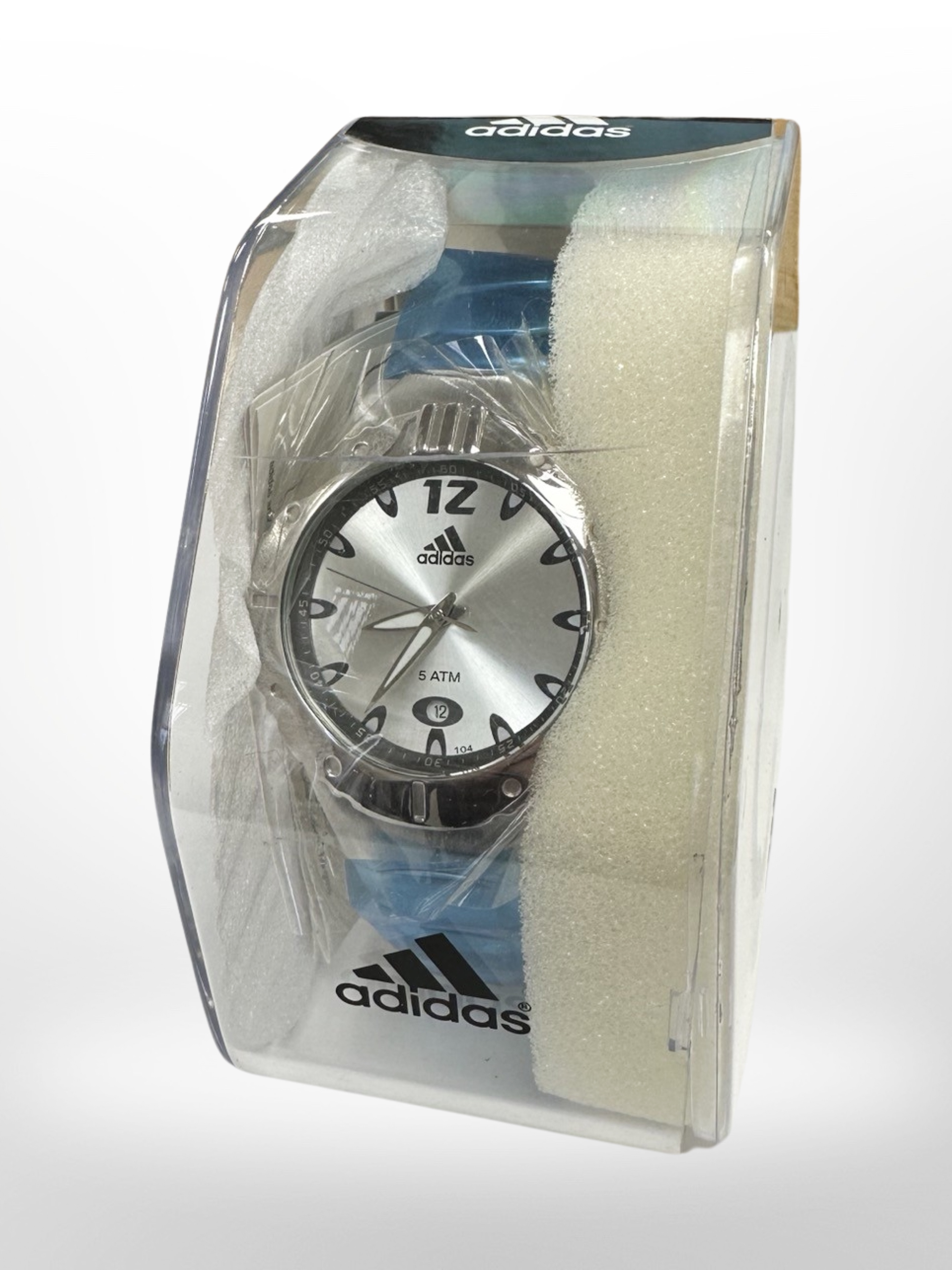 An Adidas sports watch in case