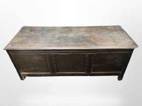 An 18th-century panelled oak coffer, 155cm wide x 59cm deep x 63cm high.