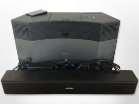 A Bose acoustic wave music system model CD-3000, and a further Bose Solo 5 TV sound system,