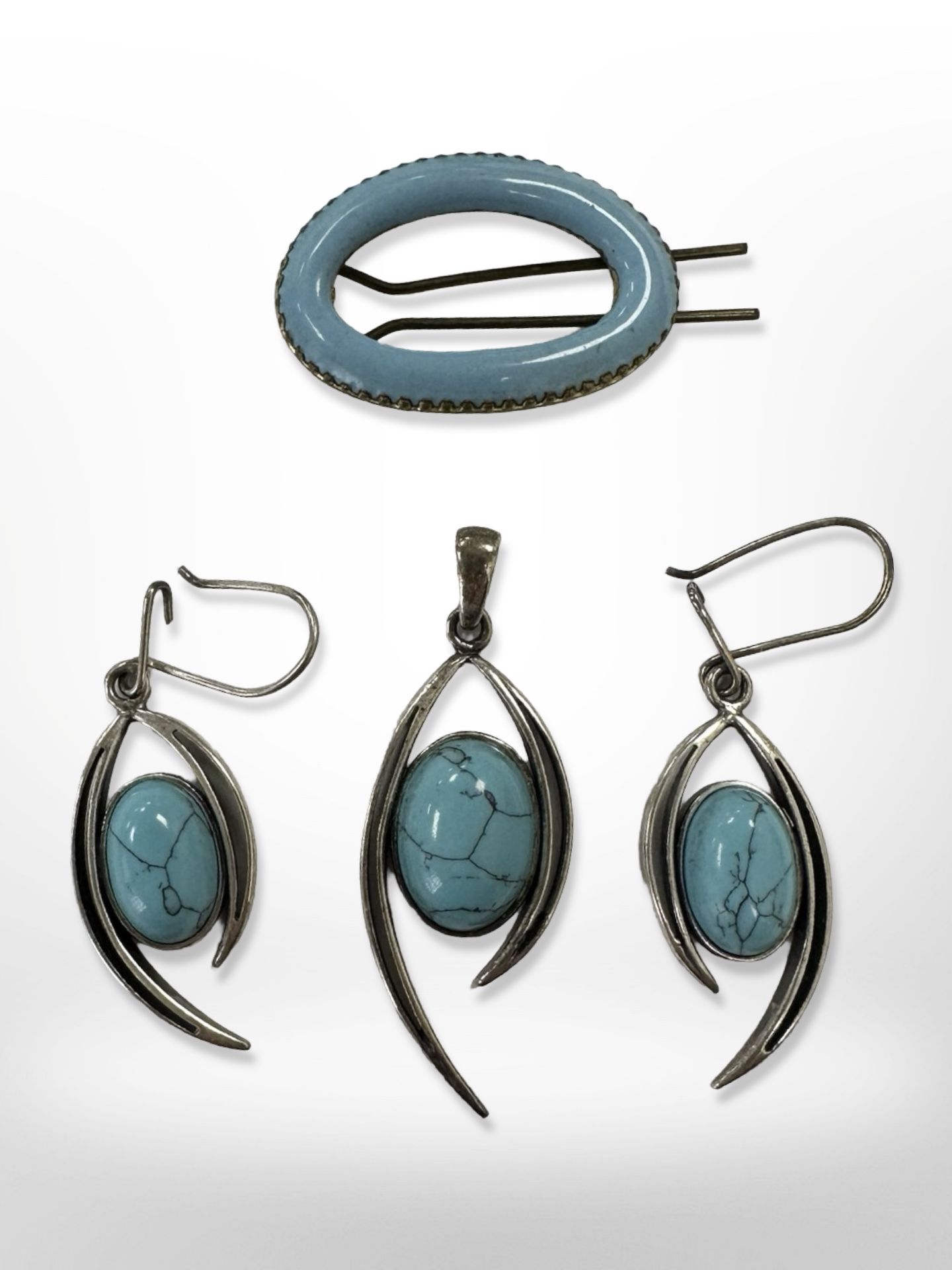 A silver and faux turquoise pendant, matching earrings,