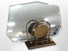 A brass gong with beater, on stand, together with an Art Deco frameless mirror, width 60cm.
