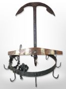 A decorative wood and cast-iron anchor, together with a hanging wrought-metal light fixture.