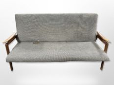 A Scandinavian teak framed three seater lounge settee, for re-upholstery,
