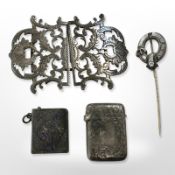 A silver belt buckle, agate-set stick pin,