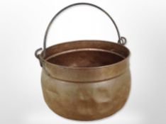 A 19th-century copper swing-handled pot, height 19cm excluding handle.