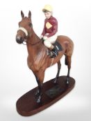A Beswick figure of Red Rum on wooden plinth.