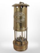 A brass E Thomas & Williams miner's lamp, number 4984.