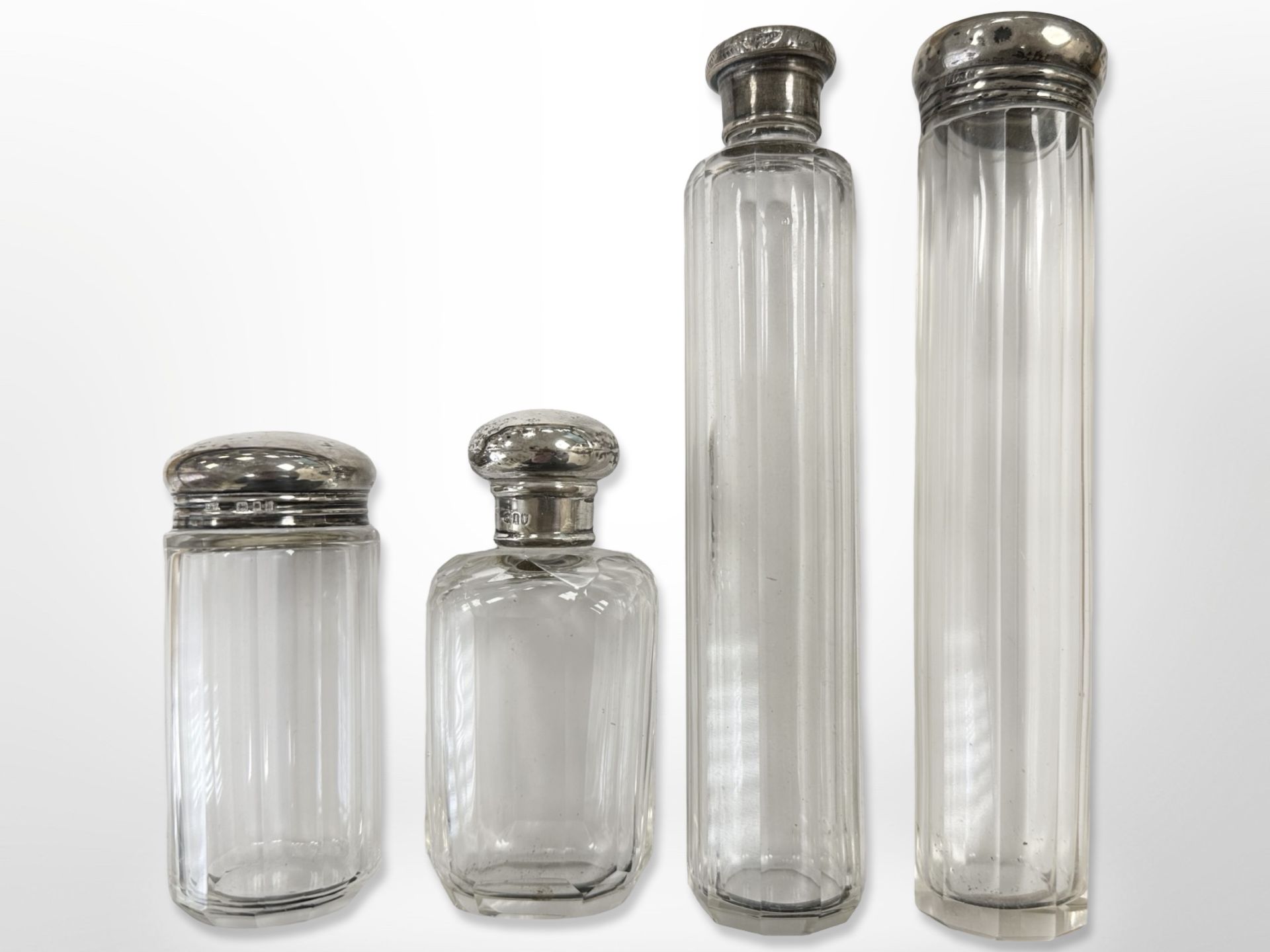 Four silver-topped crystal dressing table bottles, tallest 17.
