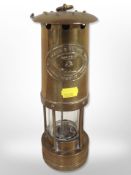 A brass E Thomas & Williams miner's lamp, number 5678.
