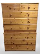 A contemporary pine five drawer chest,