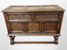 A carved oak blanket chest on stand,