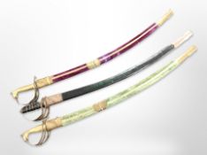 Three reproduction Indian sabres in scabbards.