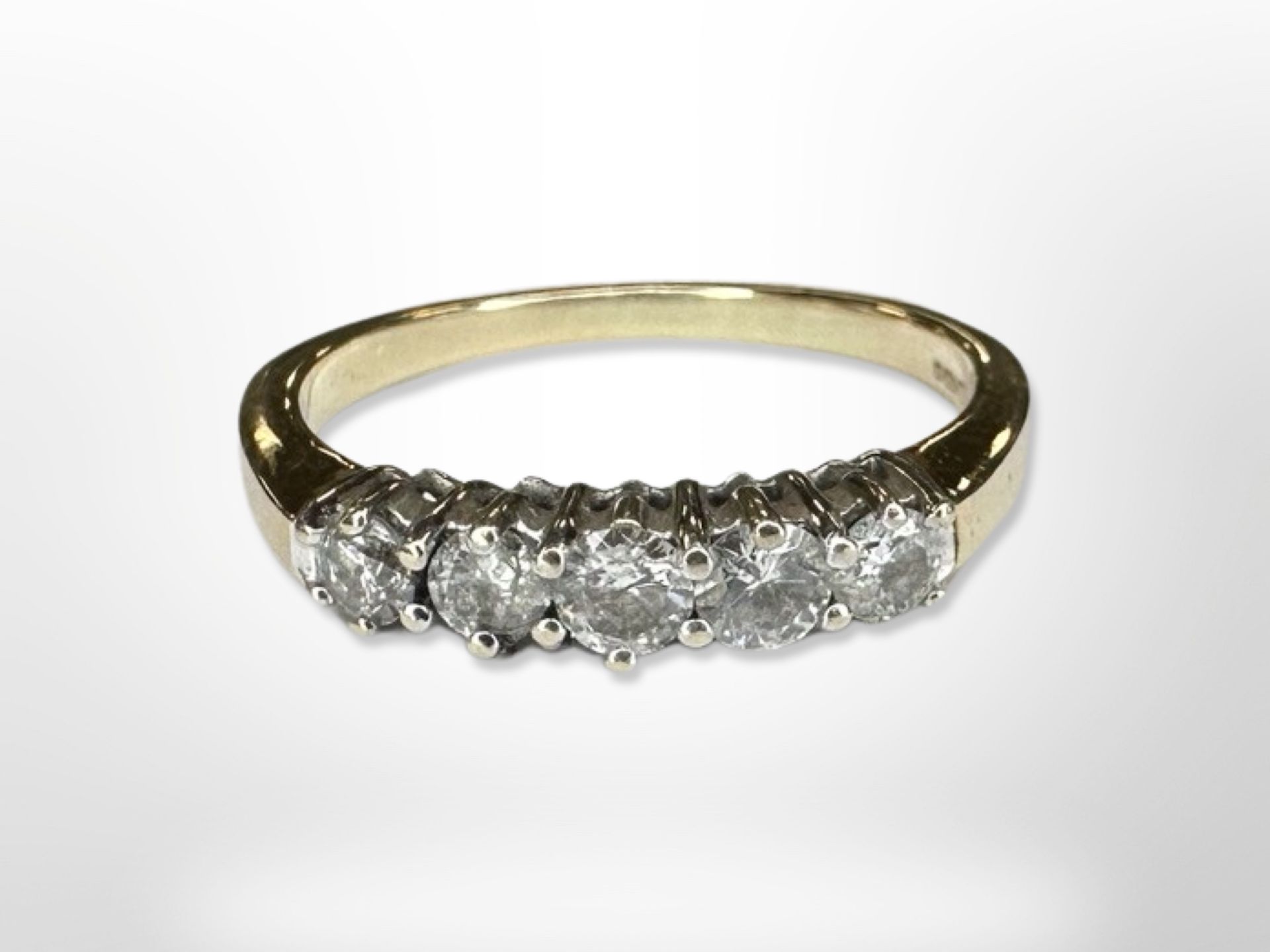 An 18ct gold five stone diamond ring, size N CONDITION REPORT: 3.