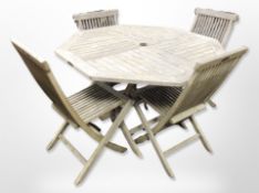 A teak octagonal folding garden table and matching set of four chairs, table 120cm diameter.