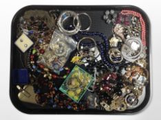 A tray of mixed costume jewellery including designer pieces by Jaeger, etc.