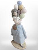 A Lladró figure of a girl with balloons, No. 5141.