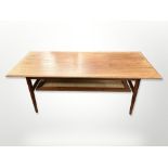 A Danish teak rectangular coffee table with rattan undershelf, 120cm long x 52cm wide x 47cm high.