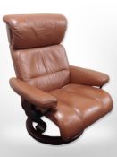 A Norwegian Ekornes Stressless swivel armchair in terracotta stitched leather