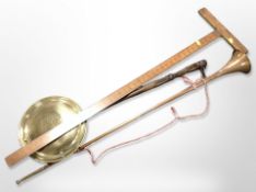 A brass bed-warming pan, a draughtsman's rule, and a copper and brass horn.