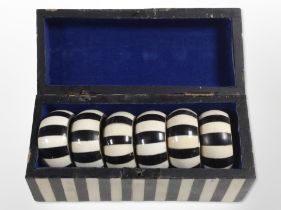 A set of six brass-mounted bone napkin rings in similar box.
