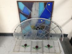 A group of five stained-glass windows including a demi-lune example measuring 108cm wide.