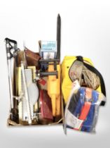 A group of power tools, spirit levels, back containing ropes and ratchet straps, etc.