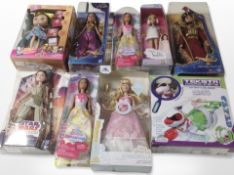 A group of Disney and other dolls, and a Teksta micro pet toy in box.
