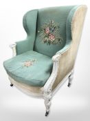 A 19th century French carved and painted wing back armchair in turquoise tapestry fabric,