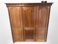 A reproduction mahogany triple-door wardrobe, 178cm wide x 60cm deep x 181cm high.