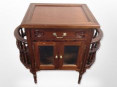 A reproduction carved hardwood low cabinet,
