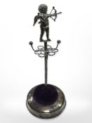 A silver ring stand surmounted by a figure of Cupid, Robert Pringle & Sons, Birmingham 1910,