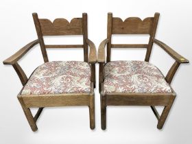 A pair of early 20th century oak armchairs upholstered in William Morris style fabric,