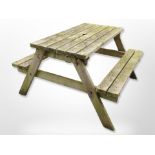 A rustic teak picnic bench, 120cm x long x 120cm wide x 70cm high.