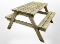 A rustic teak picnic bench, 120cm x long x 120cm wide x 70cm high.